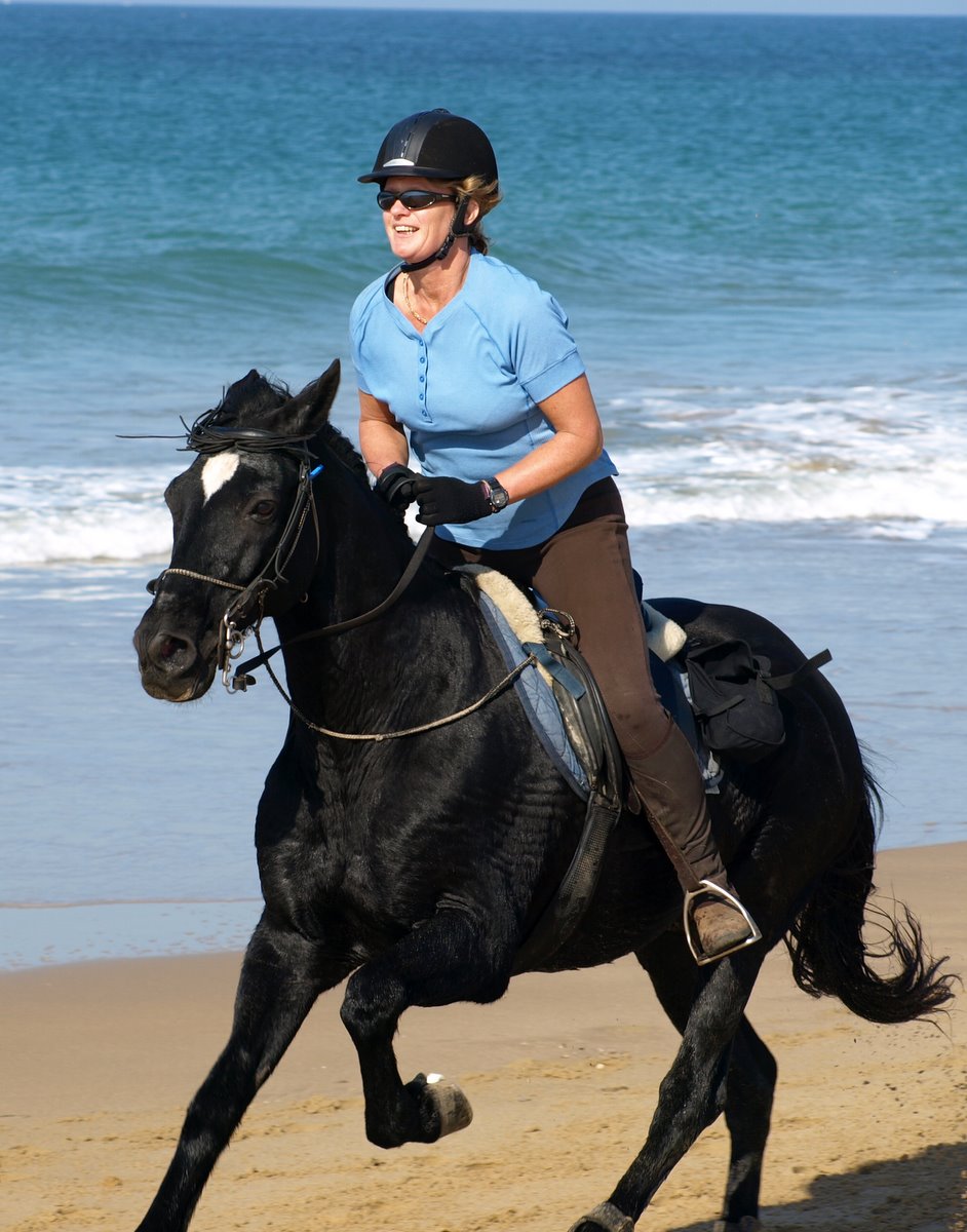 Glenys riding on a Beach in Spain