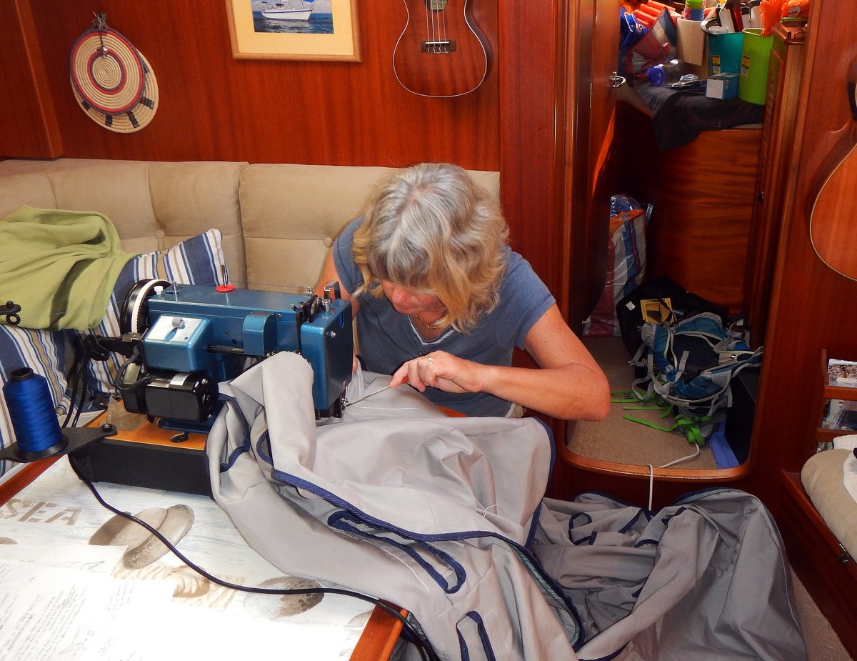 Glenys working on the dinghy cover Glenys working on the dinghy cover